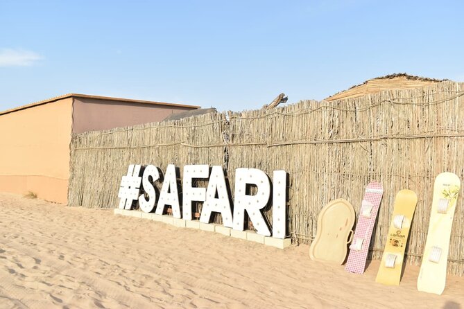 Al Ain Desert Safari with Buffet Dinner - The desert camp experience: fort-style seating, coffee, and falcon photos