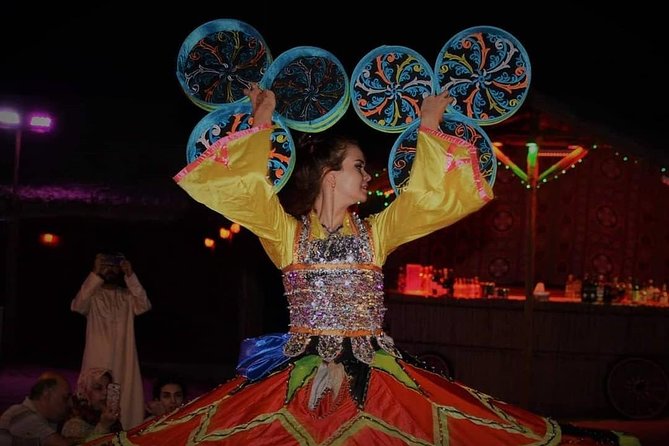 Desert Safari Red Dunes with Camel Ride, Sandboard, BBQ and Shows - The Show Lineup: Tanoura, Belly Dance, and a Fire Finale