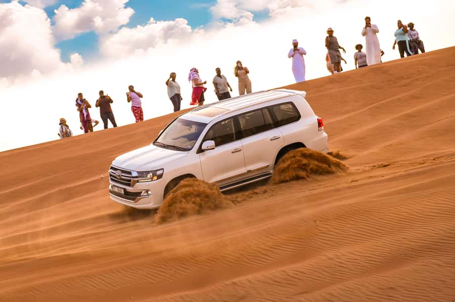 Dubai: Desert Safari with BBQ Dinner & Quad Biking Options - Camp arrivals: camel rides, henna, and falcon photos