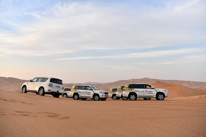 Dubai Desert Safari With Dune Bashing, Camel Ride & BBQ Dinner - Dream Night Tours campsite: camel ride, gahwa, dates, and henna