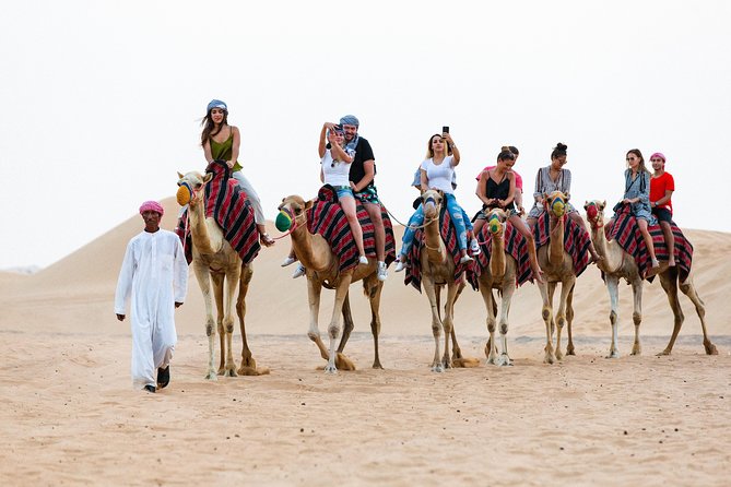 Dubai Desert Safari with Quads, BBQ Dinner, Camel ride, & Shows - Bedouin Camp Welcome: Arabic Coffee, Dates, and a Torchlit Setting