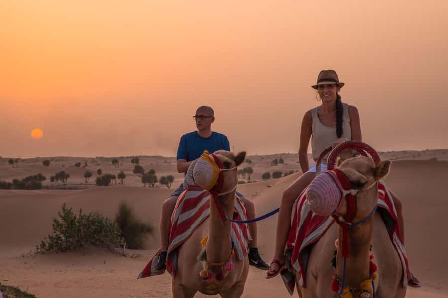 Dubai: Evening Camel Trekking & Dinner at Al Marmoom Oasis - Emirati cooking in action: coffee, bread, and sweet dumplings
