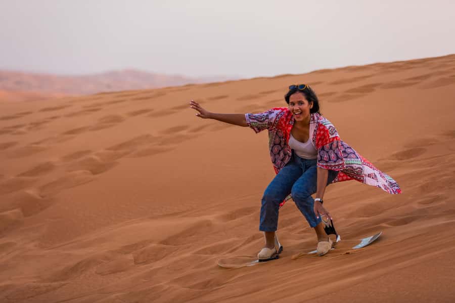 Dubai: Half-Day Desert Safari, Camel Ride, ATV & Dune Buggy - Sandboarding Turns the Dunes into a Playground