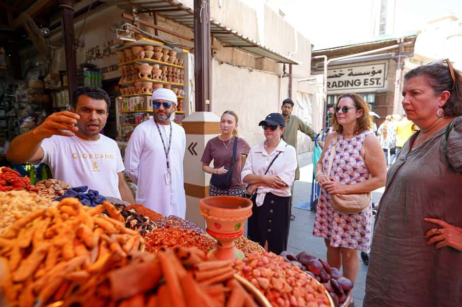 Dubai: Helicopter Ride, Old Town Walking Tour, Abra & Snacks - Old Dubai walking in Al Fahidi: wind-tower lanes and calm context