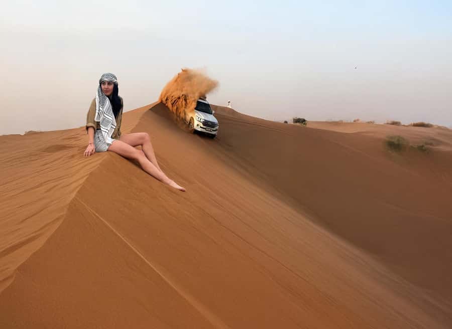 Dubai: Red Dunes Desert Safari with Premium Camp BBQ & Shows - Camel ride, sandboarding, and falcon photos: small windows with big impact