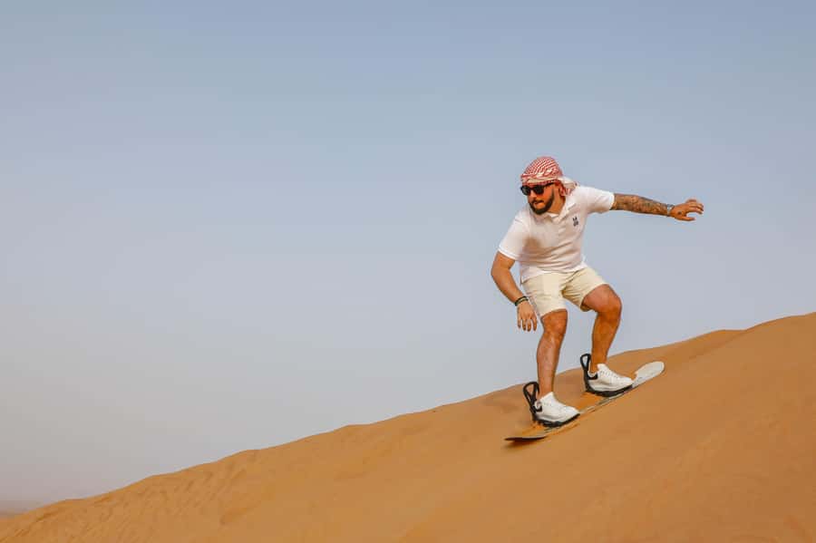 Dubai: Red Dunes Quad Bike with Sandboarding, Camels and BBQ - Sandboarding: Fun, Short, and Actually Tricky
