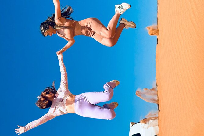 Dubai Sunset Red Dune Desert Safari, Sandboarding and Camel Ride - BBQ dinner and camp shows, plus optional quad biking