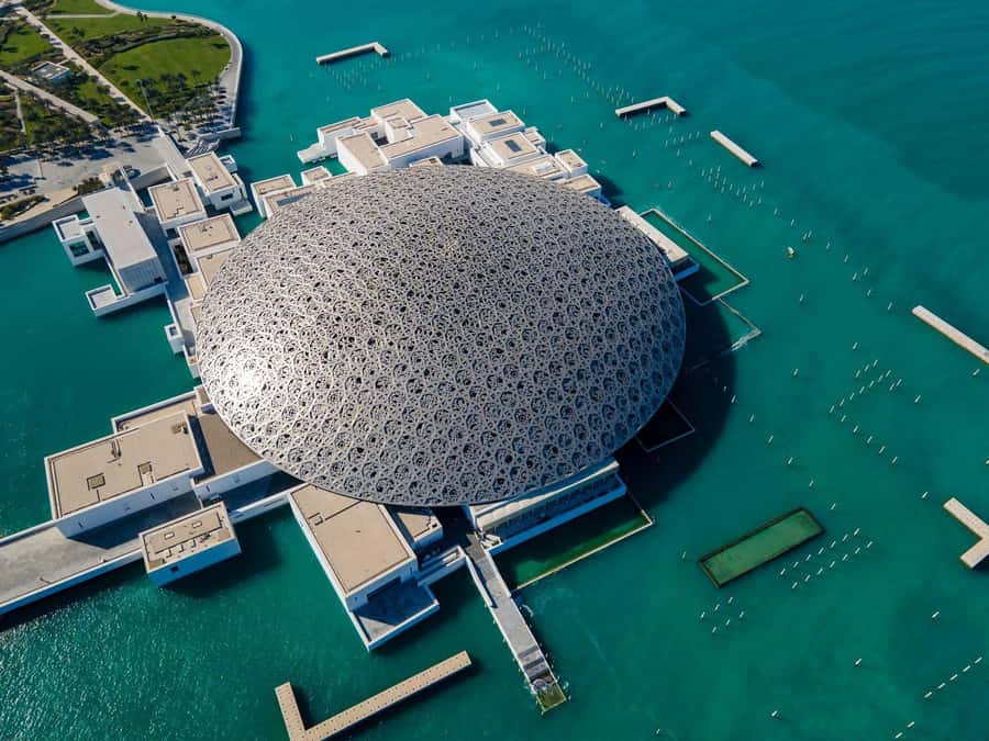 From Dubai: Abu Dhabi Grand Mosque & Louvre Museum Full-Day - Abu Dhabi Corniche photo stop: quick sea views, no pressure
