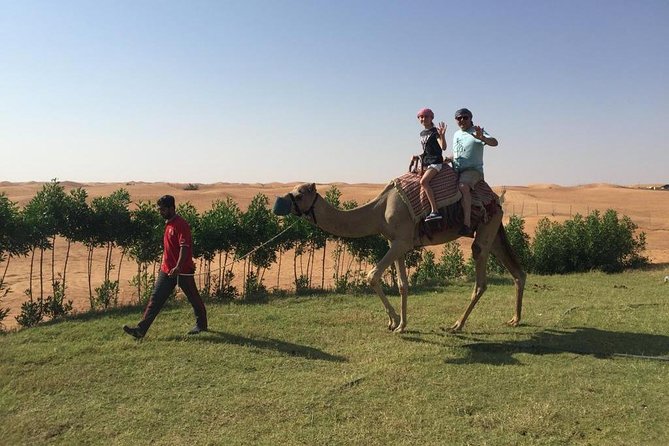 Morning Camel Trekking Over the Red Sand Dunes - The camel ride portion: timing, trainer help, and photo stops