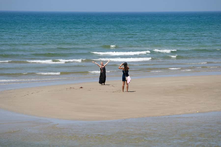 Muscat: Day Tour with Omani Lunch, Hotel Pickup, and Airfare - Qurum Beach break: swimming time plus Gulf of Oman scenery