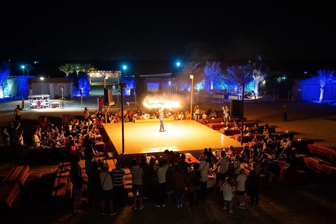 Standard Desert Safari, camel ride, BBQ Dinner, Belly Dance Show, Pick & Drop - The camp scene: dinner first, then the show lights up